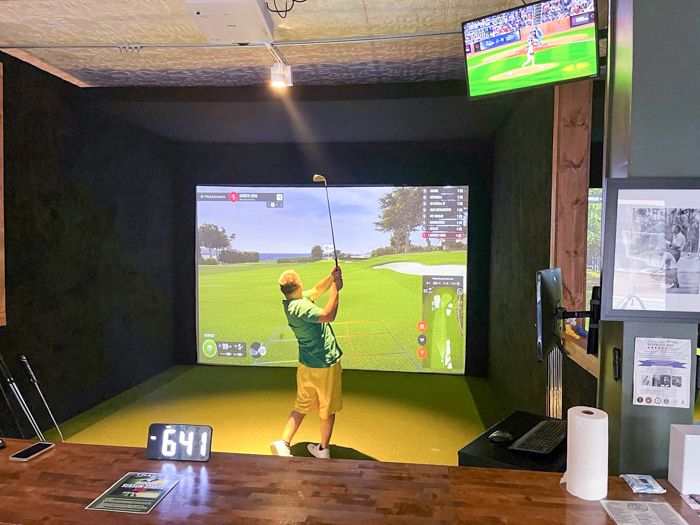 A person using a golf simulator in Pittsburgh, PA.